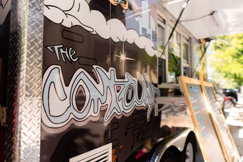 The Compound graffiti lettering on the truck
