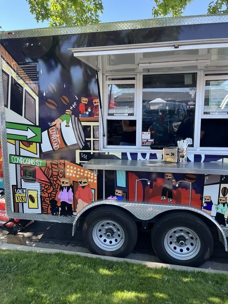 Truck service window with paper-bag character art
